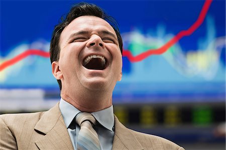 Laughing businessman in front of graph Stock Photo - Premium Royalty-Free, Code: 614-06718149