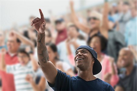 excited african american person - Man at sports game, pointing up Stock Photo - Premium Royalty-Free, Code: 614-06718174