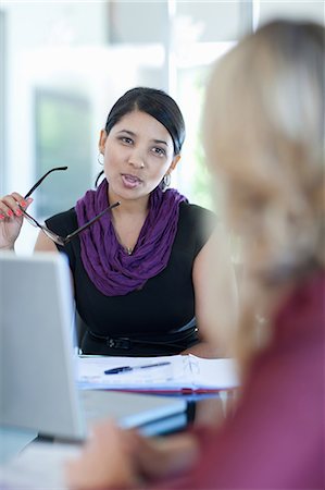 Businesswomen talking at desk Stock Photo - Premium Royalty-Free, Code: 614-06718450