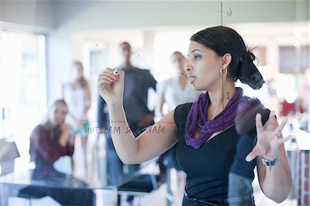 Businesswoman making graph on class Stock Photo - Premium Royalty-Free, Code: 614-06718472