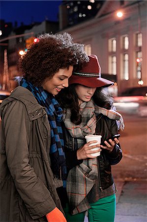 simsearch:614-06537448,k - Women using cell phone on city street Stock Photo - Premium Royalty-Free, Code: 614-06718724