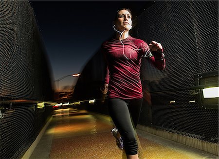 runner female - Woman running on pedestrian bridge Stock Photo - Premium Royalty-Free, Code: 614-06718844