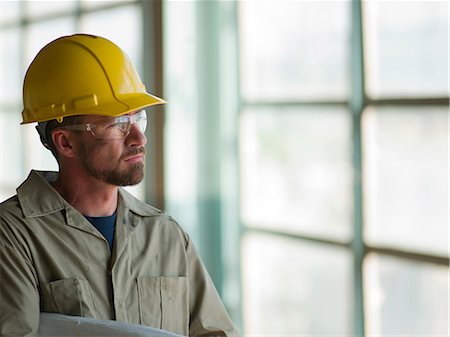 Engineer wearing hard hat on site Stock Photo - Premium Royalty-Free, Code: 614-06718847