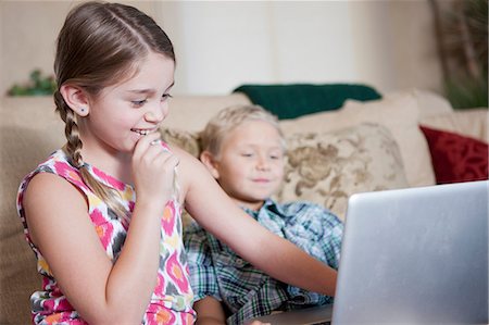 Children using laptop together on sofa Stock Photo - Premium Royalty-Free, Code: 614-06718945