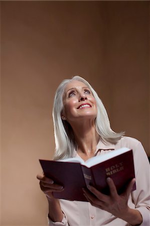 Older woman reading bible Stock Photo - Premium Royalty-Free, Code: 614-06719039