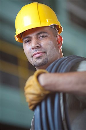 Industrial worker with wires in plant Stock Photo - Premium Royalty-Free, Code: 614-06719124