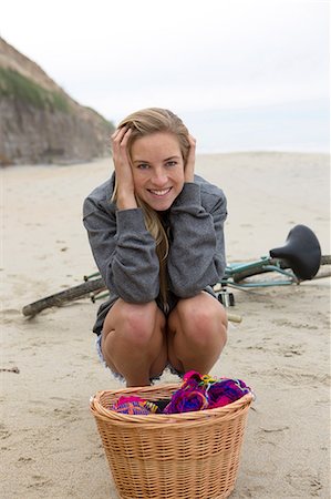 person in a basket of a bike - Woman having picnic on beach Stock Photo - Premium Royalty-Free, Code: 614-06719162