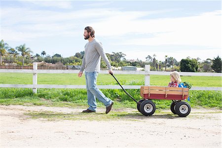 scenery children not illustration - Father pulling son in wagon Stock Photo - Premium Royalty-Free, Code: 614-06719248