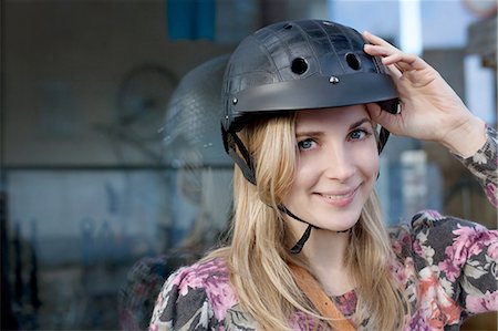 Woman wearing bicycle helmet outdoors Stock Photo - Premium Royalty-Free, Code: 614-06719633