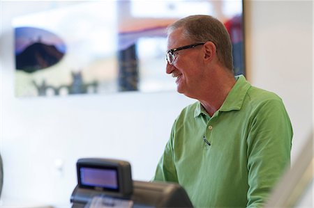 Cashier talking in store Stock Photo - Premium Royalty-Free, Code: 614-06719830