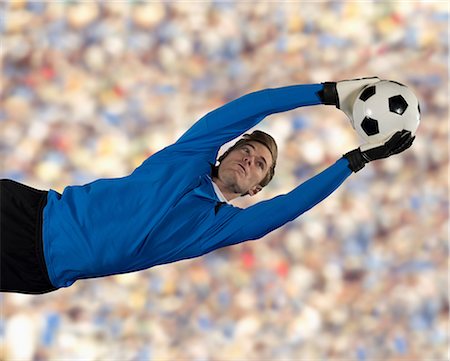 football crowd pictures - Soccer player catching ball in air Stock Photo - Premium Royalty-Free, Code: 614-06719861