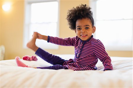 Girl playing on bed Stock Photo - Premium Royalty-Free, Code: 614-06720121