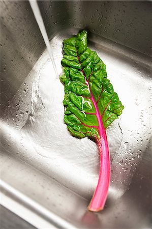 flowing - Rainbow chard being washed in sink Stock Photo - Premium Royalty-Free, Code: 614-06814101