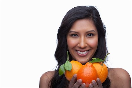 simsearch:614-06814236,k - Young woman holding oranges Stock Photo - Premium Royalty-Free, Code: 614-06814189