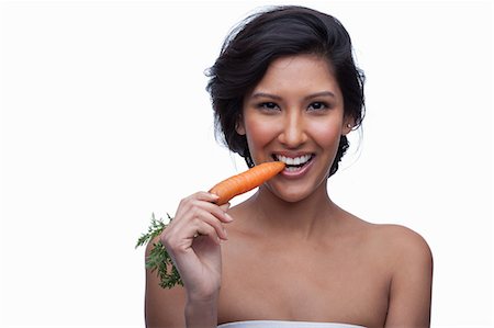 simsearch:614-06814236,k - Young woman biting carrot Stock Photo - Premium Royalty-Free, Code: 614-06814198