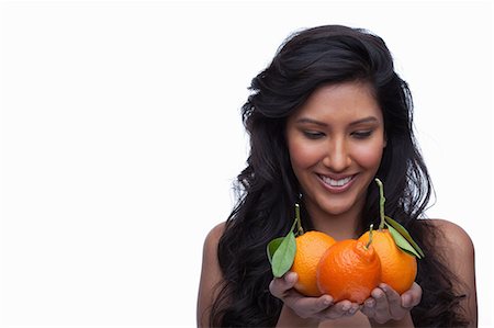 simsearch:614-06814236,k - Young woman holding oranges Stock Photo - Premium Royalty-Free, Code: 614-06814190