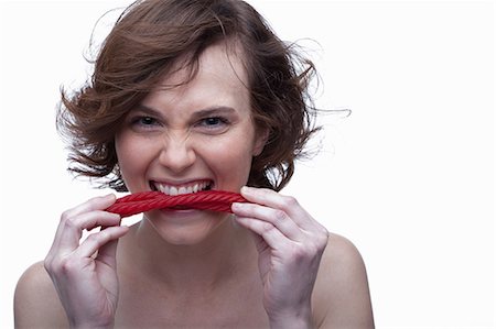 simsearch:614-06814236,k - Young woman biting candy Stock Photo - Premium Royalty-Free, Code: 614-06814216
