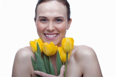 simsearch:614-06814236,k - Young woman with flower in hair and hands on face Stock Photo - Premium Royalty-Free, Code: 614-06814224