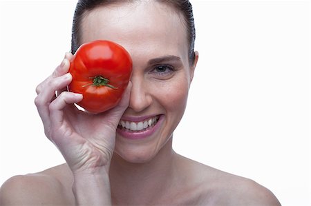 simsearch:614-06814236,k - Young woman covering eye with red tomato Stock Photo - Premium Royalty-Free, Code: 614-06814226