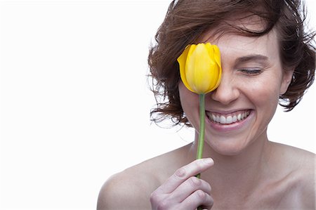 simsearch:614-06814236,k - Young woman holding yellow tulip with eyes closed Stock Photo - Premium Royalty-Free, Code: 614-06814220