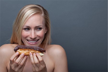 simsearch:614-06814236,k - Young woman with chocolate eclair Stock Photo - Premium Royalty-Free, Code: 614-06814244