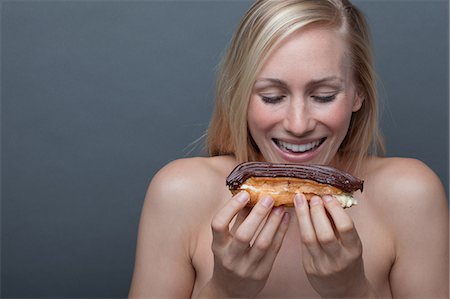simsearch:614-06814236,k - Young woman with chocolate eclair Stock Photo - Premium Royalty-Free, Code: 614-06814243