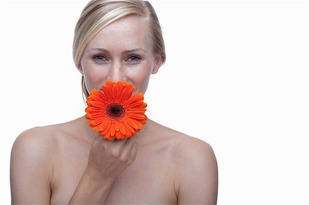 simsearch:614-06814236,k - Young woman with orange flower Stock Photo - Premium Royalty-Free, Code: 614-06814256