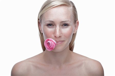 simsearch:614-06814236,k - Young woman with pink flower in mouth Stock Photo - Premium Royalty-Free, Code: 614-06814258