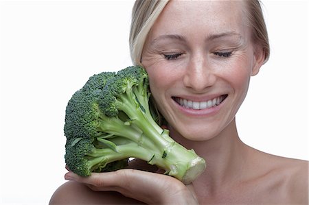 Young woman with broccoli Stock Photo - Premium Royalty-Free, Code: 614-06814252