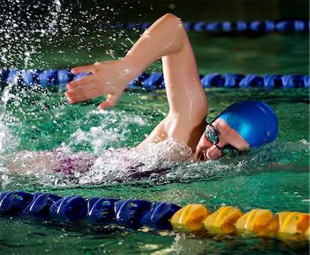 Teenage girl doing front crawl in swimming pool Stock Photo - Premium Royalty-Free, Code: 614-06814277