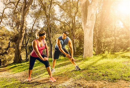 Two people exercising in forest doing warm up stretches Stock Photo - Premium Royalty-Free, Code: 614-06813168