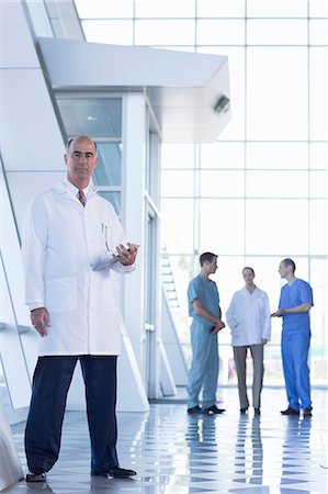 Male doctor holding medical records Stock Photo - Premium Royalty-Free, Code: 614-06813244