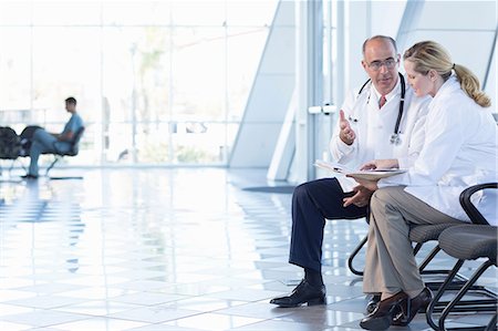 Male and female doctors sitting on chairs Stock Photo - Premium Royalty-Free, Code: 614-06813241