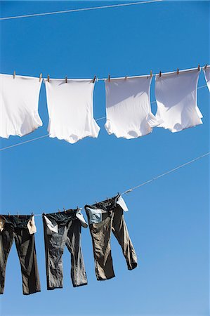 T shirts and trousers on clothes line Stock Photo - Premium Royalty-Free, Code: 614-06813279