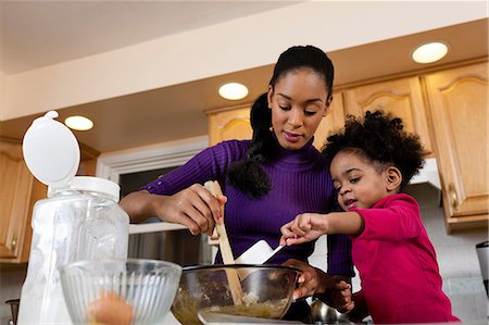 Mother and daughter baking cookies in kitchen Stock Photo - Premium Royalty-Free, Code: 614-06813597