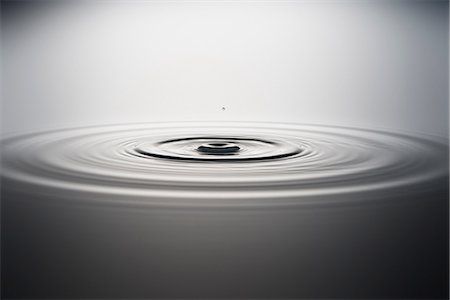 Water droplet falling into water Stock Photo - Premium Royalty-Free, Code: 614-06813719