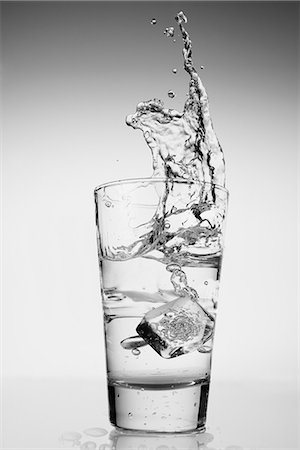 splash - Ice cube falling into glass of water Stock Photo - Premium Royalty-Free, Code: 614-06813735