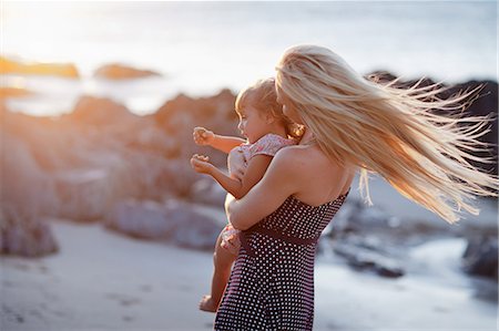 spotted (pattern) - Mother holding daughter on beach Stock Photo - Premium Royalty-Free, Code: 614-06813927