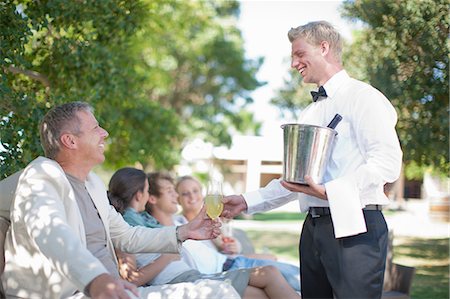 smile woman 40s - Waiter serving customers in garden Stock Photo - Premium Royalty-Free, Code: 614-06813986