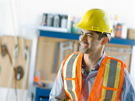 Mid adult construction worker smiling Stock Photo - Premium Royalty-Free, Code: 614-06895837