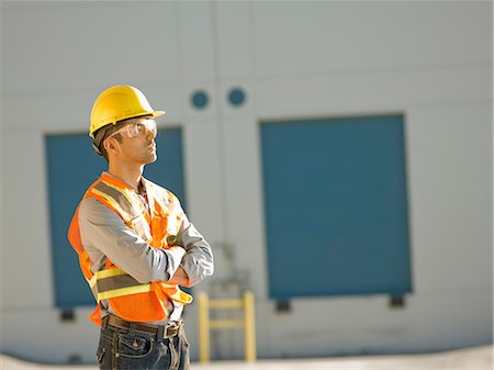Mid adult construction worker with arms folded Stock Photo - Premium Royalty-Free, Code: 614-06895839