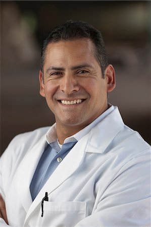 Mature man wearing lab coat and smiling, portrait Stock Photo - Premium Royalty-Free, Code: 614-06896124