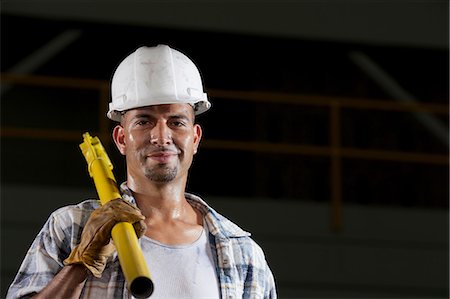 strong (human physical strength) - Mid adult construction worker wearing hard hat and holding tool, portrait Stock Photo - Premium Royalty-Free, Code: 614-06896140