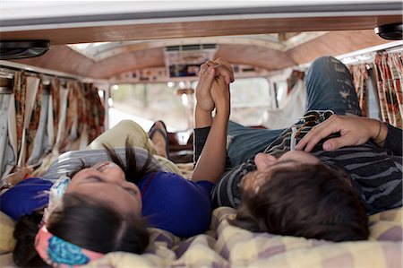 simsearch:614-06896253,k - Couple lying together in the back of camper van, holding hands Stock Photo - Premium Royalty-Free, Code: 614-06896160