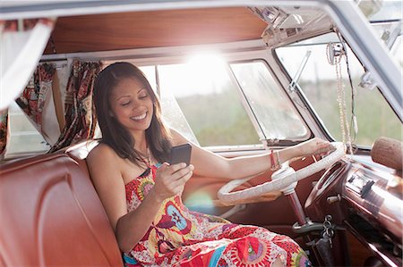 Young woman using mobile phone in camper van Stock Photo - Premium Royalty-Free, Code: 614-06896191