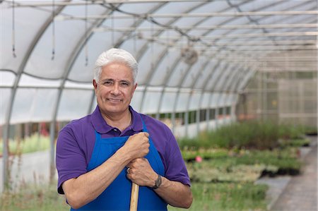 Senior man working in garden centre, portrait Stock Photo - Premium Royalty-Free, Code: 614-06896232