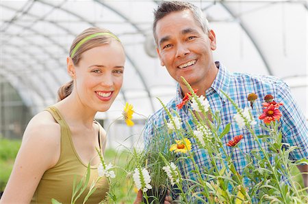 portrait man shirt shop - Mature man and mid adult woman shopping in garden centre, smiling Stock Photo - Premium Royalty-Free, Code: 614-06896290