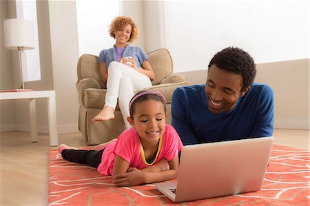 simsearch:614-06896477,k - Father and daughter on floor using laptop Stock Photo - Premium Royalty-Free, Code: 614-06896472