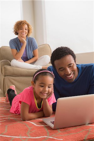 simsearch:614-06896477,k - Father and daughter on floor using laptop Stock Photo - Premium Royalty-Free, Code: 614-06896473