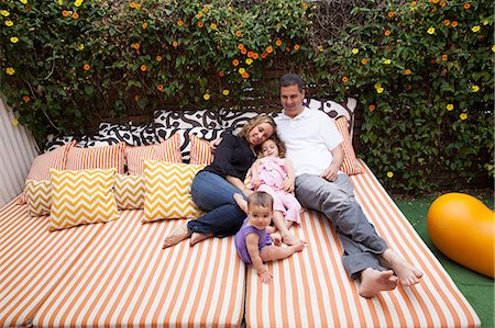 Family relaxing outdoors on cushions Stock Photo - Premium Royalty-Free, Code: 614-06896691